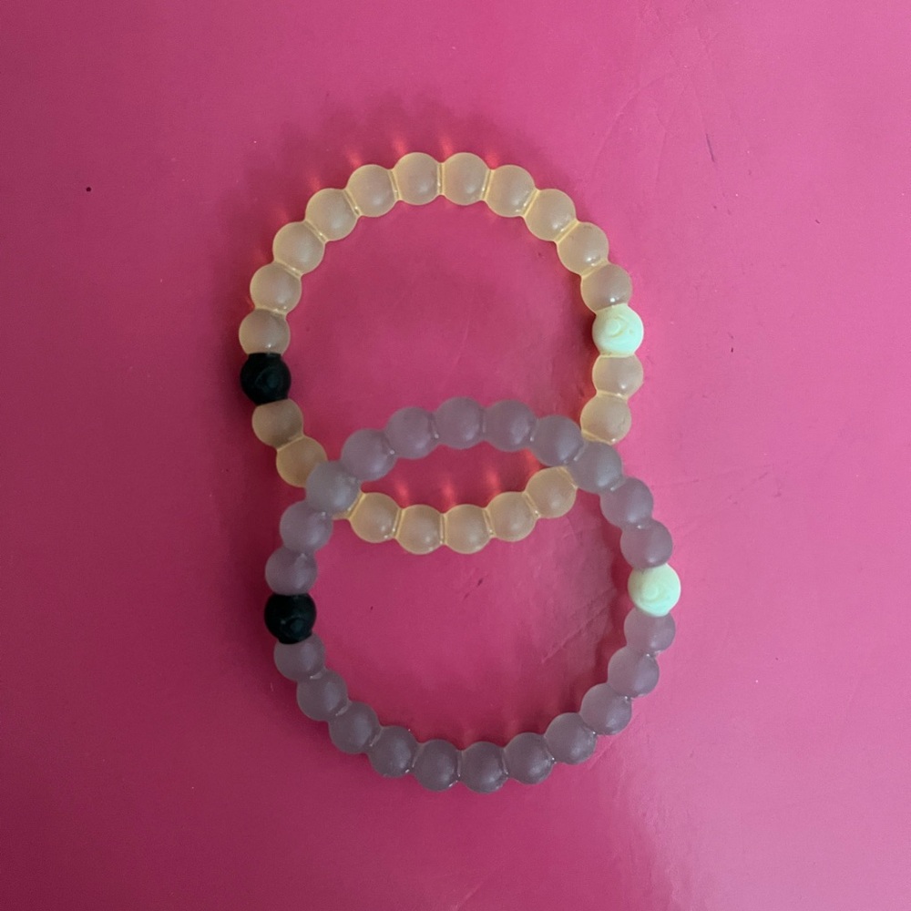 White and purple Lokai bracelets